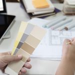 Graphic design and color swatches and pens on a desk. Architectural drawing with work tools and accessories.